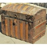 A late 19th century tin lathe overlay travelling trunk with domed lid,