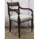 A Regency mahogany bar back carver chair with reeded splat and down swept open arms over an