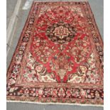 North west Persian Borchalue carpet with a central medallion and an all over floral pattern on a