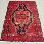 North west Persian Nahawand rug with a central elongated stepped medallion on a predominantly red