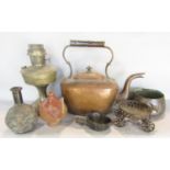 A large copper kettle, along with the base of a brass oil lamp, an Indian cooking vessel, an