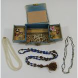 Quantity of costume jewellery to include an Egyptian style 800 silver fob, coquilla nut bead