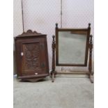 A small late Victorian oak hanging corner cupboard enclosed by a rectangular carved floral