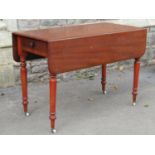 A Victorian mahogany Pembroke table fitted with a frieze drawer raised on ring turned and tapered