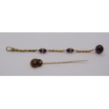 Antique 15ct chain fob with garnet and baroque pearl beads, together with a yellow metal stick pin