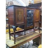 An Edwardian mahogany side cabinet freestanding and enclosed by three panelled doors, the central