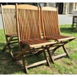 A set of four good quality contemporary folding hardwood garden chairs with slender slatted seats