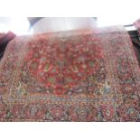 Central Persian Kashan carpet with a central floral medallion and an all over floral pattern on a
