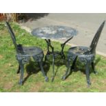 A dark green painted cast aluminium garden terrace table of circular form with decorative pierced