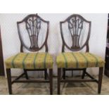A pair of Georgian mahogany Hepplewhite style dining/side chairs, the pierced shield shaped back