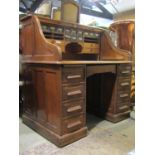 An early 20th century oak roll top desk stamped to lock 'Angus London', the S shaped tambour roll