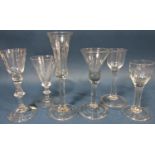 Four Georgian solid stemmed wine glasses of varying design , a flared conical wine glass with