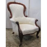 A Victorian drawing room chair with cream ground repeating floral patterned upholstered seat back
