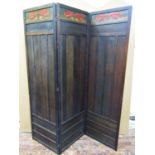 An art nouveau three fold room divider of full height in oak, with poker work floral detail and