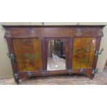 An arts and crafts wall mounted hall stand, the central mirror panel flanked by two decorated