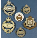 Four WWII Royal Tank Regiment cap and lapel badges, East Sussex cap badge, etc