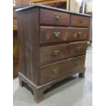 A small Georgian oak bedroom chest of three long and two short graduated drawers set on bracket