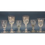 Three Georgian baluster wine glasses, two further floral engraved wine glasses and a smaller