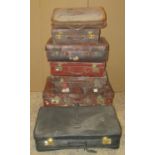 A collection/stack of vintage leather and fibre luggage (af)