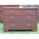 An Edwardian oak arts and crafts style dressing chest of three long graduated drawers, with anodised
