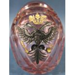 A single pale pink cut glass Faberge style Easter egg bearing a Black Russian Imperial doodle headed