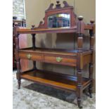 A late Victorian walnut three tier buffet with raised back incorporating a arched bevelled edge