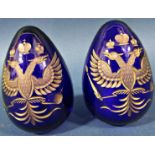 A pair of cobalt blue cut glass gilded Faberge style Easter eggs both bearing the Russian Imperial