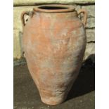 An old weathered terracotta oviform jar with moulded loop handles, moulded rim and glazed collar, 52