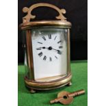 A French carriage clock, the oval case enclosing an eight day timepiece (running)