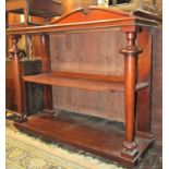 A Victorian mahogany three tier buffet raised on turned and tapering supports with arched shaped