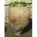 An old oviform jar with green glazed neck and open moulded loop handles, 57 cm high