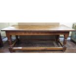 A traditional oak refectory table, the heavy planked top with cleated ends, raised on four turned