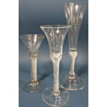 A tall Georgian fluted Champagne glass with a spiral stem, a waisted bucket wine glass with spiral