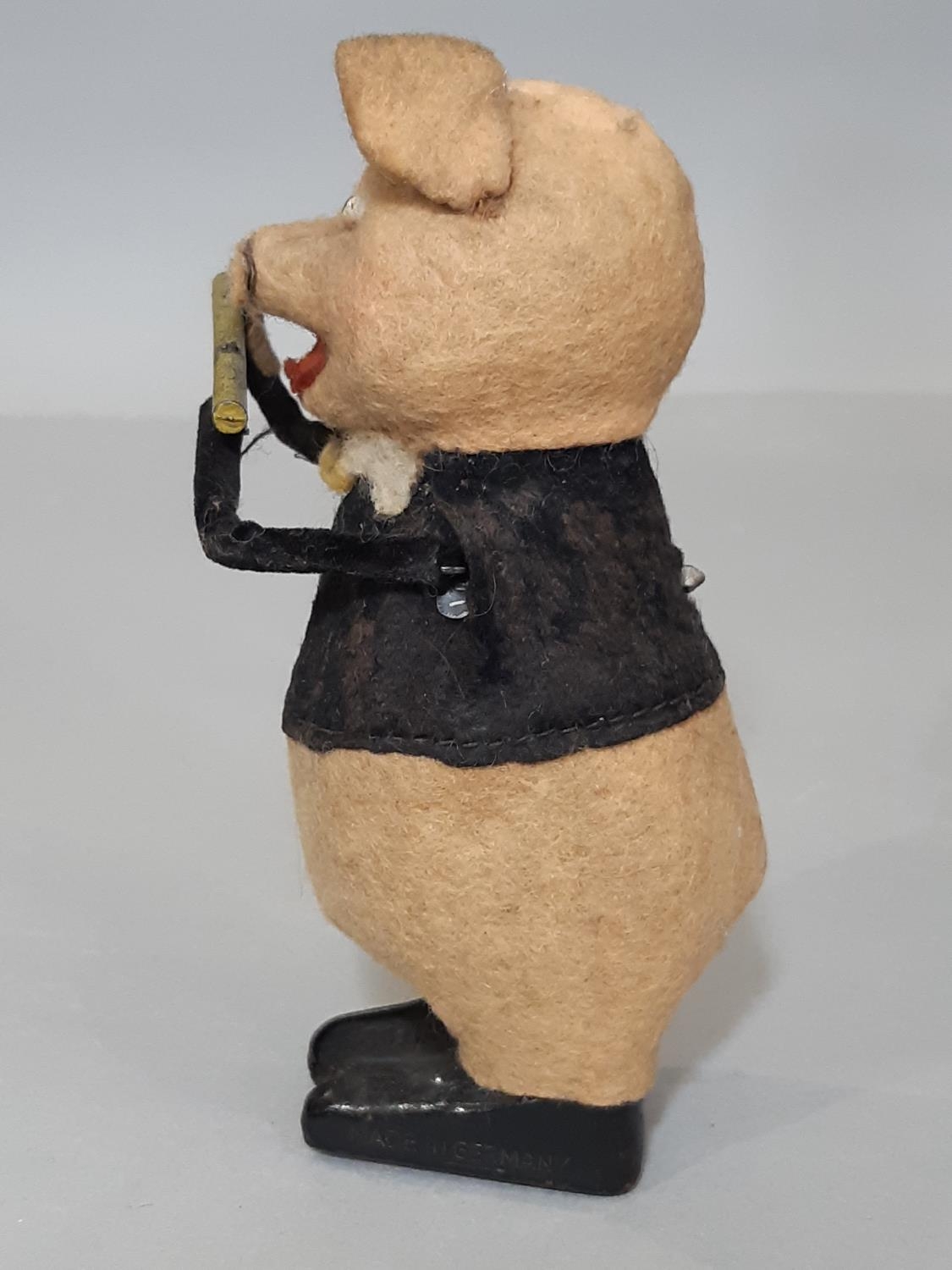 A Schuco clockwork toy in the form of a pig playing a flute, height 11cm, no key - Bild 2 aus 5
