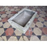 A small shallow natural stone trough of rectangular form, 54 cm long x 36 cm wide x 15 cm deep