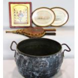 An oval cast iron cooking pot, a pair of bellows, two oval watercolours of coastal scenes and