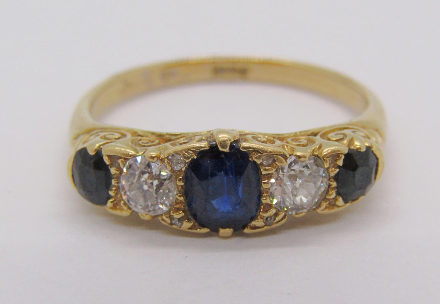 18ct sapphire and diamond five stone ring with scrolled setting, diamonds 0.20ct each approx, size