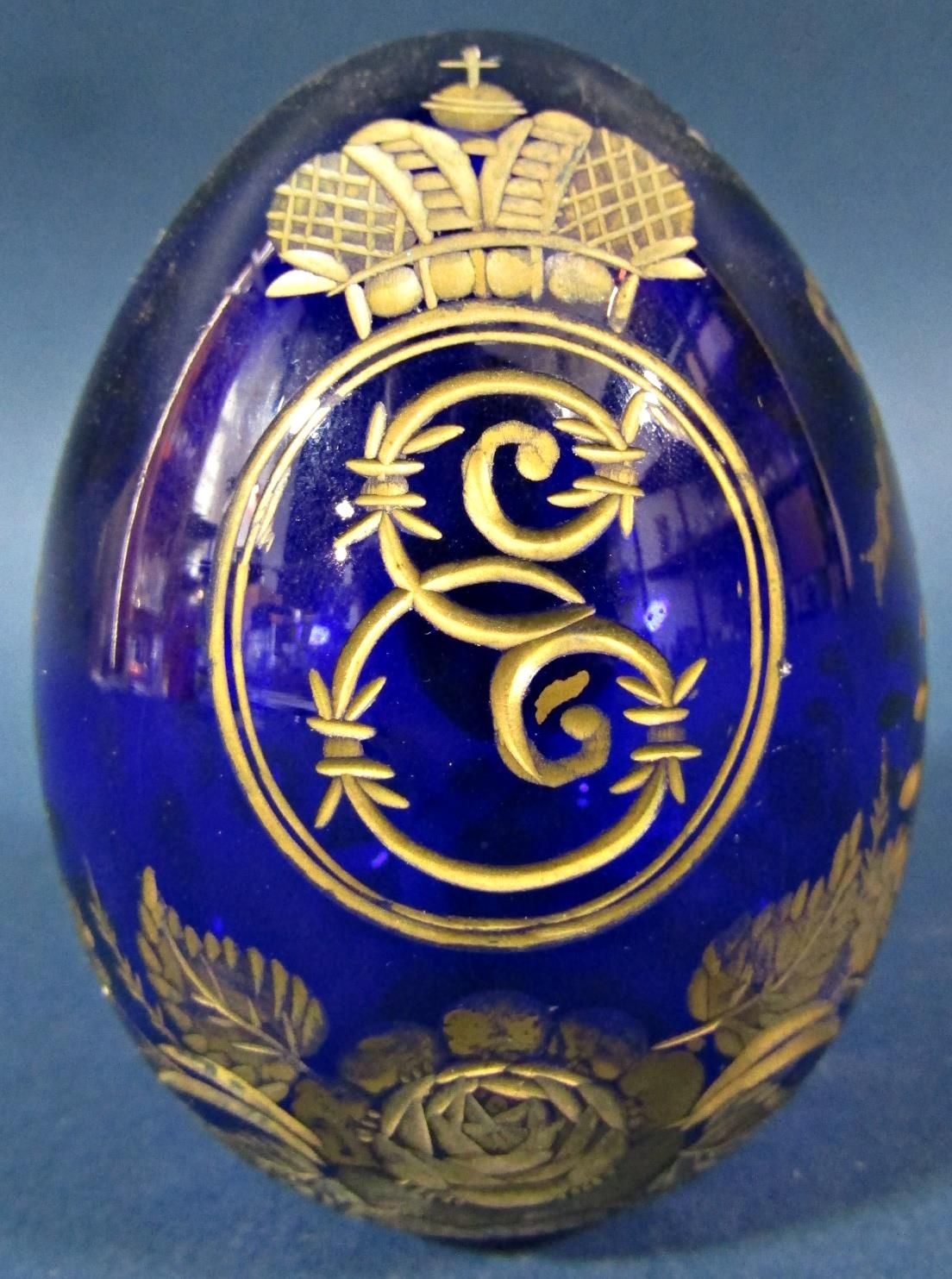 A single cobalt blue cut glass and gilded Faberge style Easter egg bearing an Imperial monogram