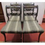 Four Regency simulated rosewood sabre leg dining chairs with brass inlaid detail and upholstered