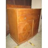 An Edwardian satinwood veneered shallow bow fronted side cupboard floorstanding and enclosed by a