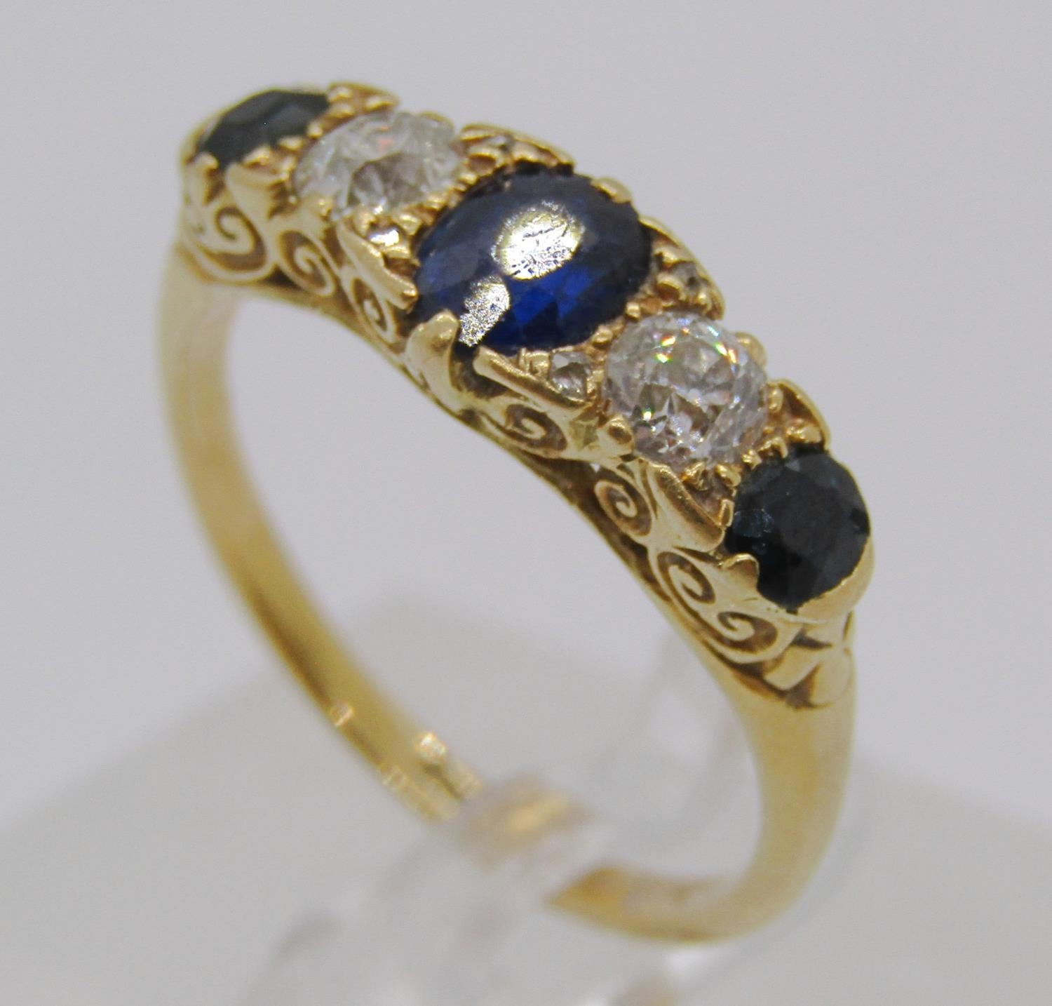 18ct sapphire and diamond five stone ring with scrolled setting, diamonds 0.20ct each approx, size - Bild 2 aus 4