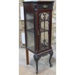 A slender Edwardian mahogany side cabinet enclosed by a rectangular glazed panelled door with