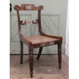 A Regency single chair with scrolled splats, reeded and moulded frame, cane panelled seat and raised