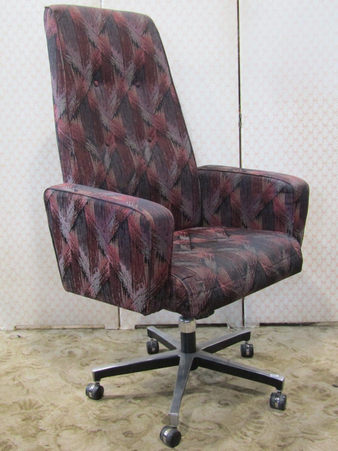 A Tansad swivel high back office desk chair with repeating colourful lattice pattern upholstery
