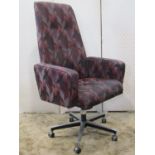 A Tansad swivel high back office desk chair with repeating colourful lattice pattern upholstery