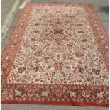 A Persian design carpet with an all over floral pattern and running floral borders, 300cm x 200cm