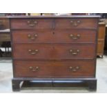 A Georgian mahogany bedroom chest of two short over three long graduated drawers set on bracket