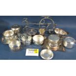 A mixed selection of silver plated items including a sauce boat, dishes bowls , bottle rest,