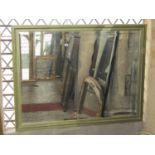 A large contemporary antique style wall mirror of rectangular form with bevelled edge plate within a