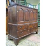 An 18th century Welsh oak linen chest with rising lid over four arched and fielded panels, the lower